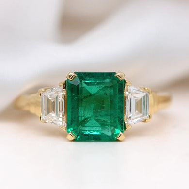 custom emerald trilogy engagement ring